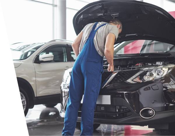 a mechanic checking car engine